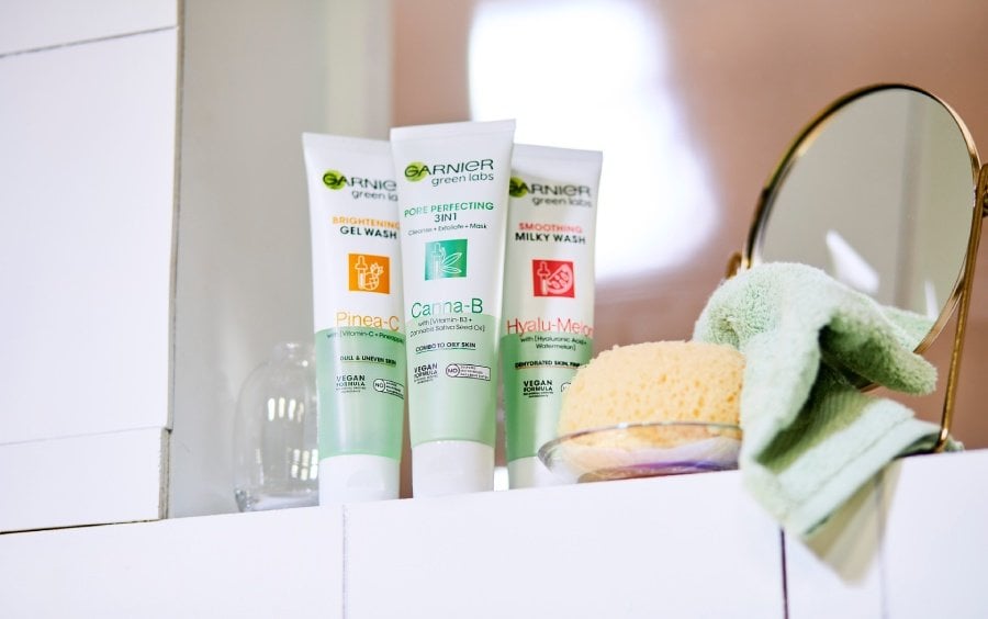 Three tubes of Garnier cleanser on a bathroom shelf